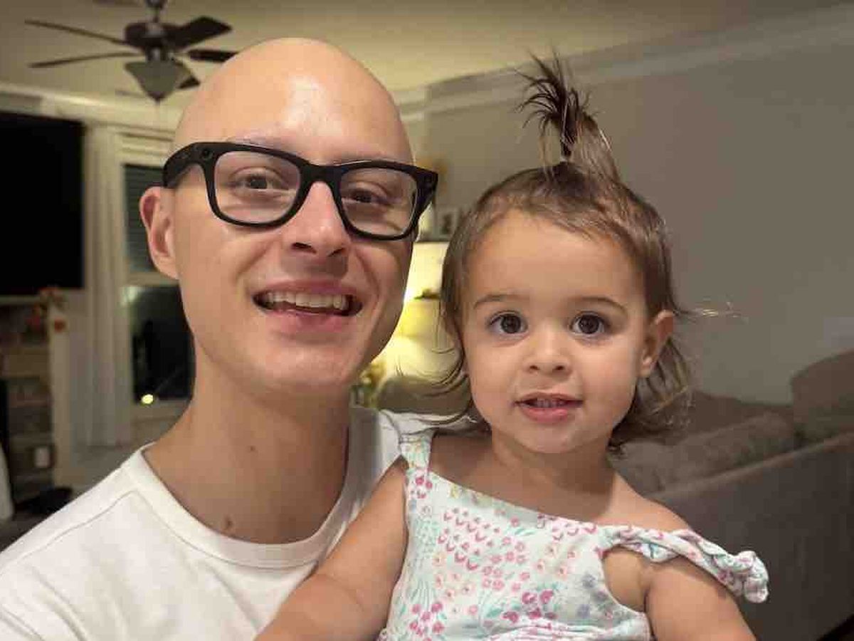 Tyler smiling for a selfie with his daughter Lucia at home