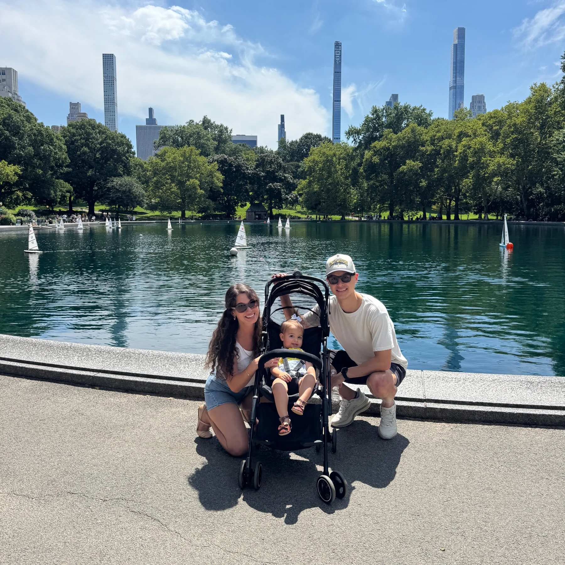 Tyler, Danielle, and Lucia together beside the Conservatory Water in Central Park